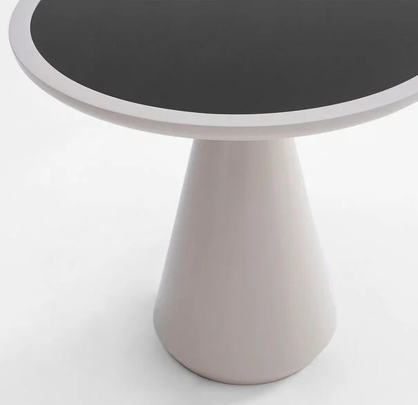 This close up of the Addie side table, from a higher vantage point, shows the black glass inlayed to the resin base. The piece shown here is our solid white finish.
