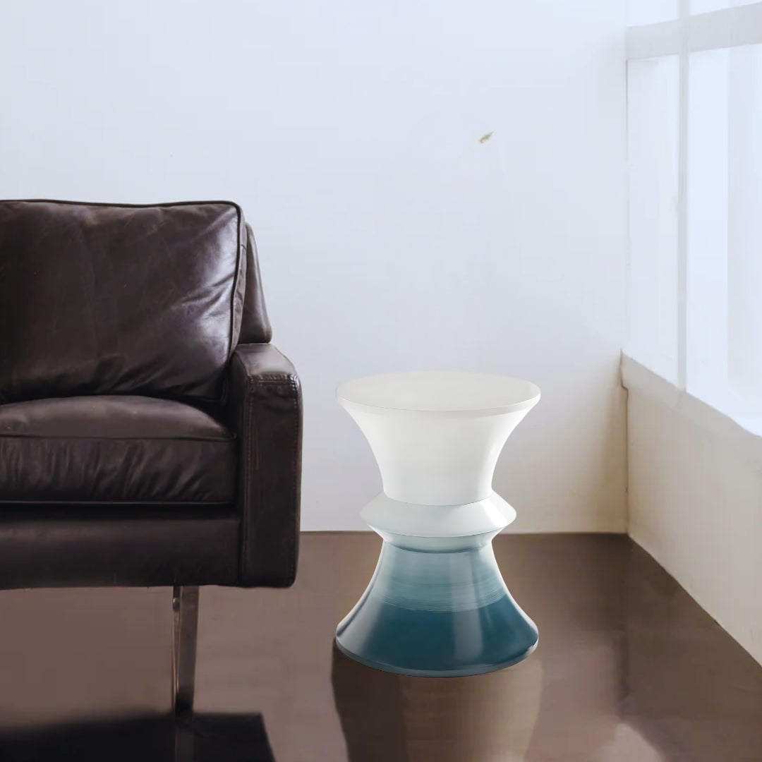 This is a lifestyle shot of the Cuff from Modern Elements, showcasing the resin table's hourglass silhouette and blue to white gradient finish.