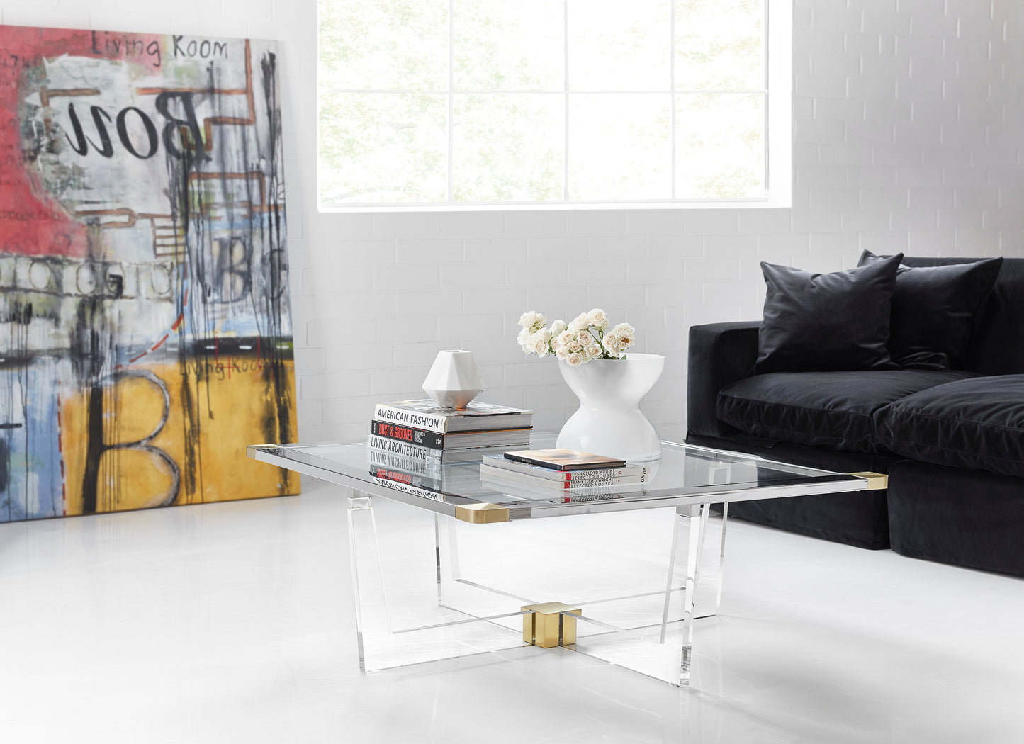 Pictured here, the Clarion Cocktail Table is the epitome of modern elegance, blending luxurious materials with a sleek, contemporary design. This stunning cocktail table features a satin brass finish that adds a touch of opulence, while the acrylic base creates a sense of lightness and sophistication.