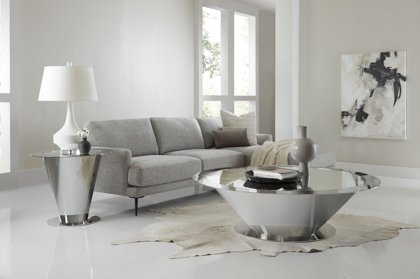 This is a lifestyle shot of the Cosmos cocktail table from Modern Elements, which showcases the futuristic design and reflective elements of the Cosmos.
