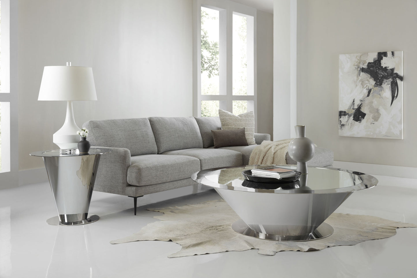 This is a photo of the Cosmos lamp table and cocktail table by Modern Elements (a great pairing to really bring a futuristic element to a room). This photo shows off both of the Cosmos' inverted cone-shaped base and reflective stainless steel base and its mirroring glass insert top.