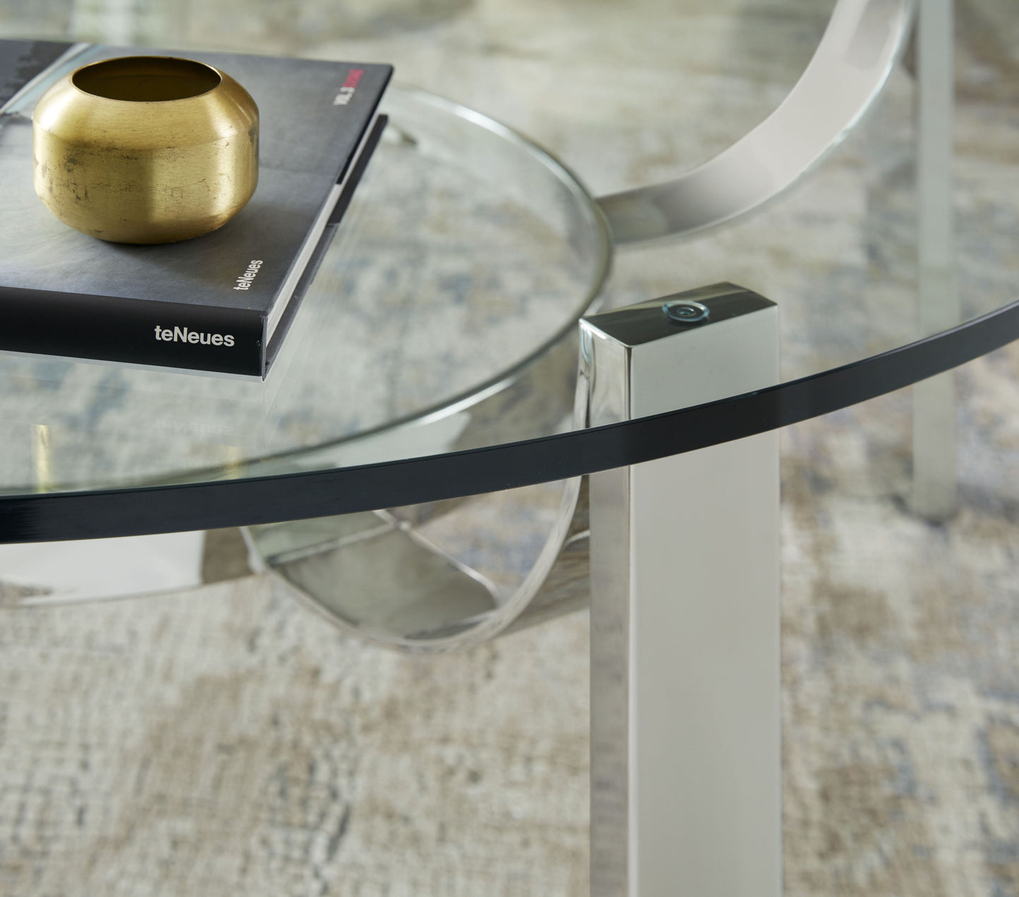 The Tahoe Cocktail Table is a perfect embodiment of modern elegance and timeless design, making it a standout piece for any contemporary living room or lounge area.
This quintessentially modern cocktail table features a sleek metal frame with clean, geometric lines that create a minimalist yet striking base. Topped with a round glass tabletop, the Tahoe Cocktail Table offers a versatile surface that adds an airy and sophisticated touch to any decor.