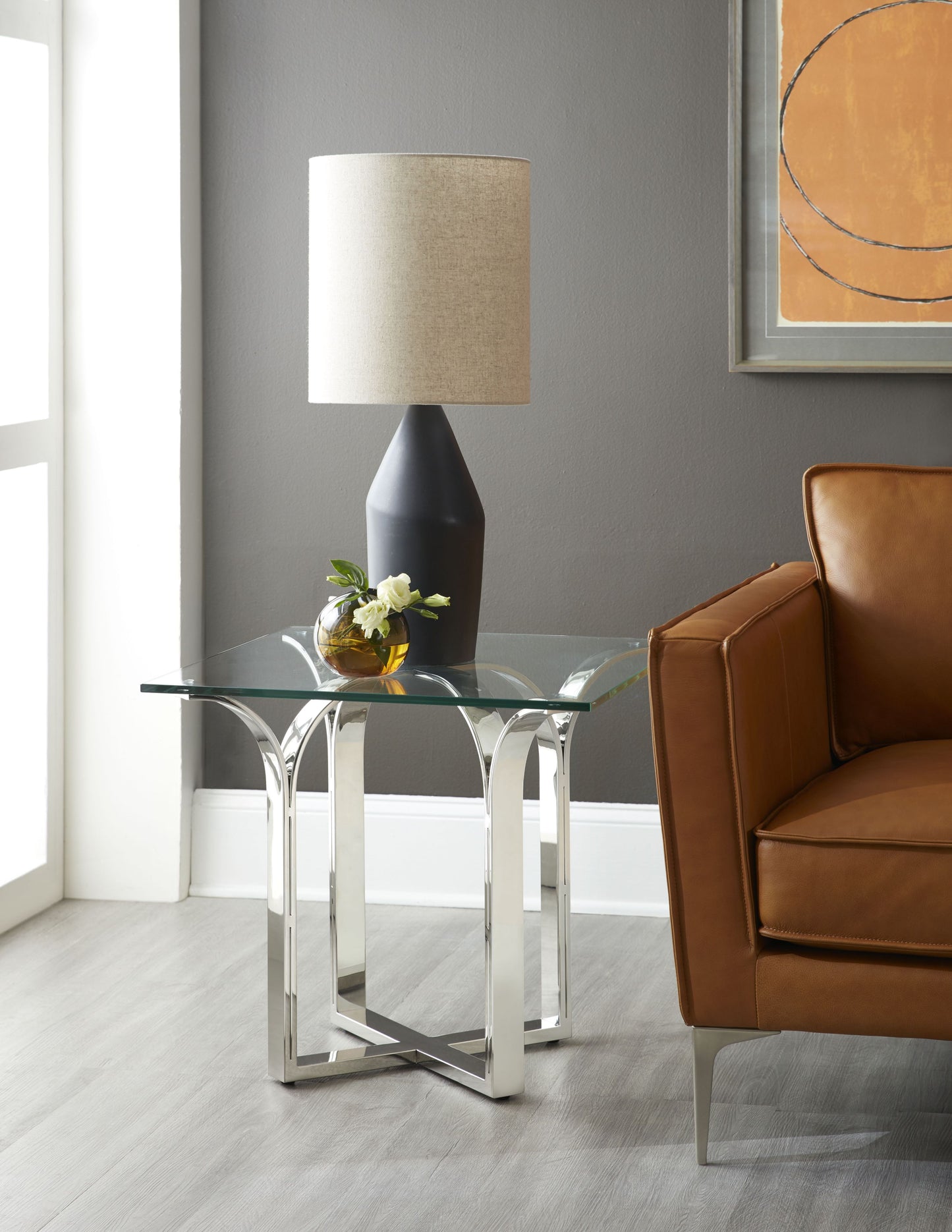 Pictured here is the Trellis Square accent table. Featuring a sleek stainless steel base with intricate geometric patterns inspired by a traditional trellis design, this square-topped accent table introduces a striking architectural element to your decor. The square glass tabletop offers a clean, crisp surface that enhances the table’s contemporary appeal, while the timeless design ensures it complements a variety of interior styles.