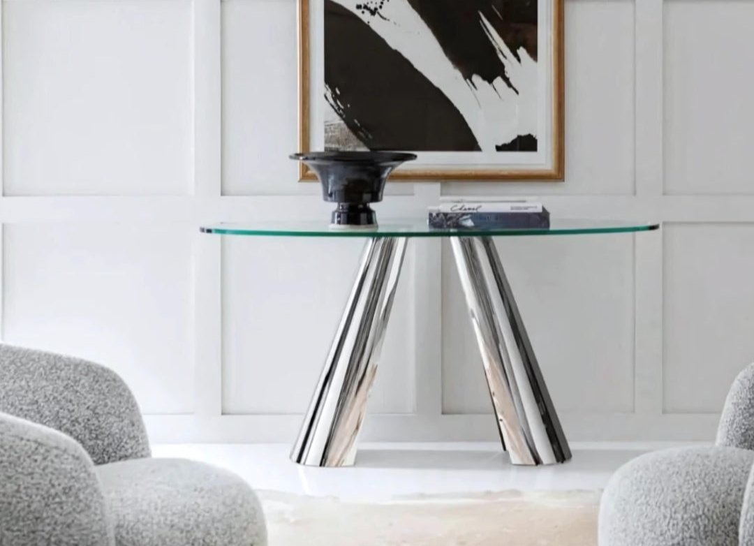 Pictured here is a lifestyle shot of The Arro Console table in a living room. This metal and glass table by Modern Elements features clean lines and minimalist design concept.