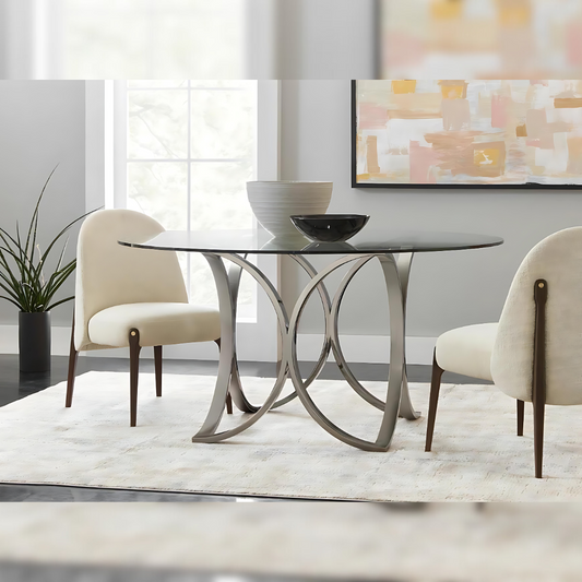 Pictured here is a lifestyle shot of the Diana dining table. The combination of the reflective metal base and the transparent glass top ensures that "The Diana" elevates the ambiance of your dining room, making every meal feel like a five-star experience. Whether hosting dinner parties or enjoying a casual meal, this table promises to bring a touch of luxury and comfort to your home.