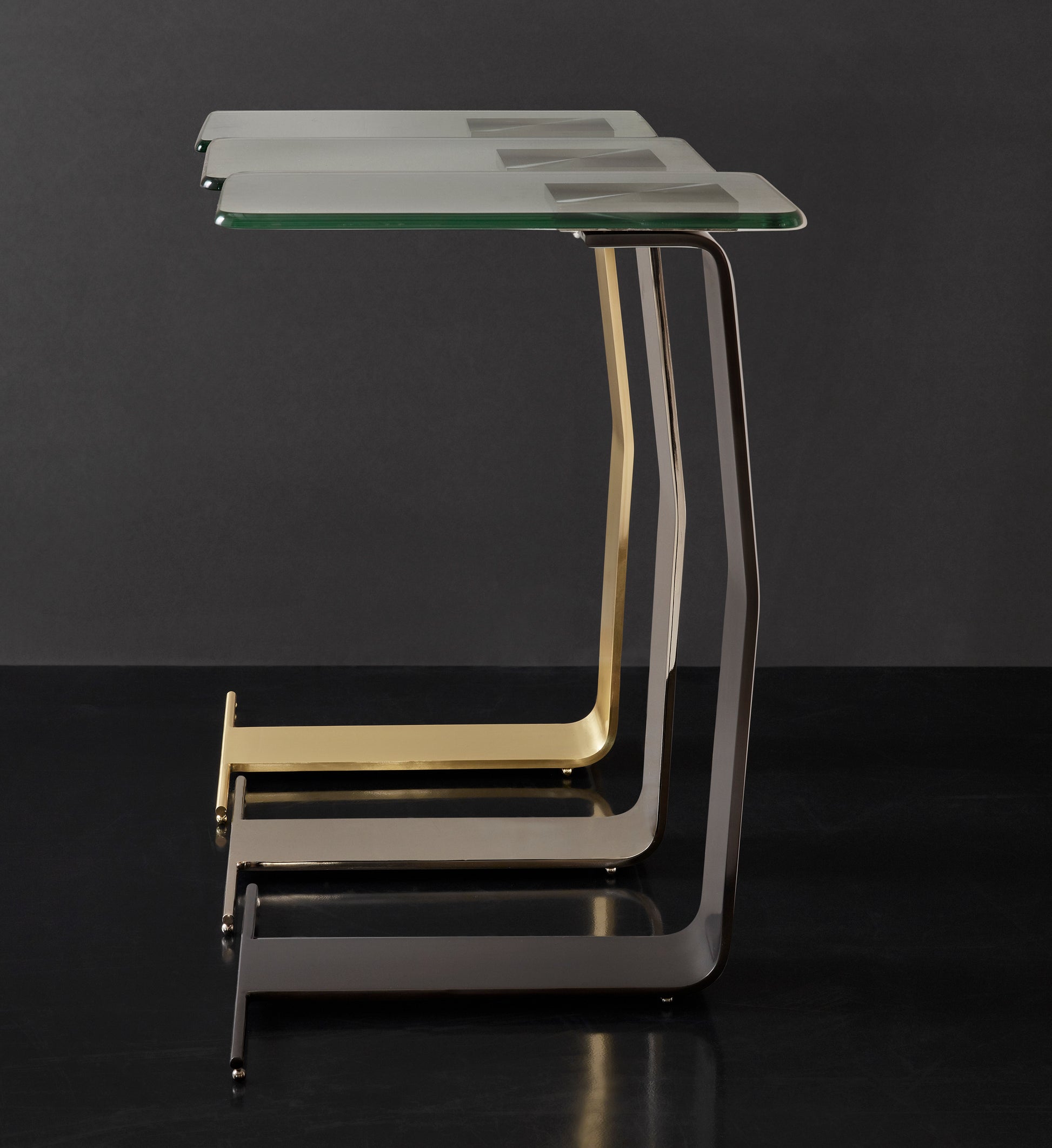 This is a group of silo photos of the Plateau side table by Modern Elements in various finishes.

Featuring a clear glass tabletop that rests on a sleek, sculptural metal frame, this metal and glass side table adds a touch of sophistication to your home decor. The unique frame, crafted from a single piece of metal, creates a contemporary sculpture-like form that serves as both a functional end table and a stylish accent piece.