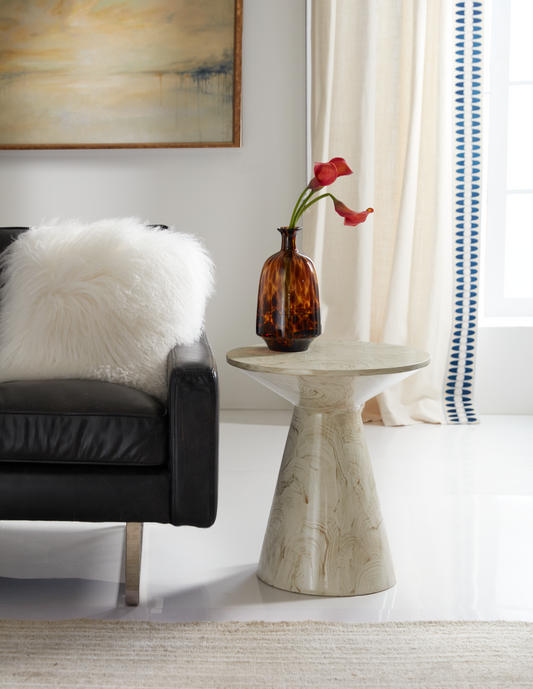 The Hardin End Table is a beautifully crafted accent piece that brings a touch of elegance to any room. Showcased in a stunning Faux Malachite finish, this American-made resin table stands out as a unique and custom treasure for your home.

Its distinctive truncated hourglass form adds visual interest and a sculptural element to your living space, while its compact size makes it perfect as a pull-up or side table.