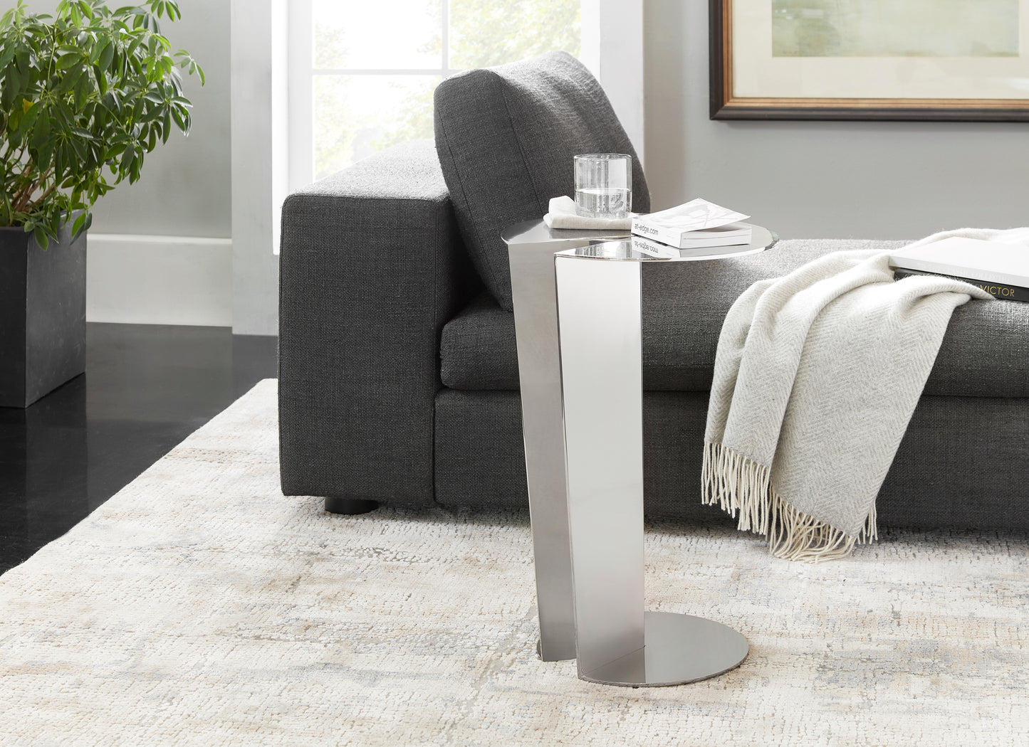 Featured in this lifestyle image, "The Pacman" Metal Accent Table is a bold, futuristic piece that brings a touch of luxury to any living room or lounge area.

Crafted entirely from metal, this contemporary accent table features a distinctive tabletop design inspired by the iconic video game character, making it an instant conversation starter. Its clean geometric lines and low-profile frame seamlessly connect the metal base to the metal top, creating a sleek and modern silhouette.