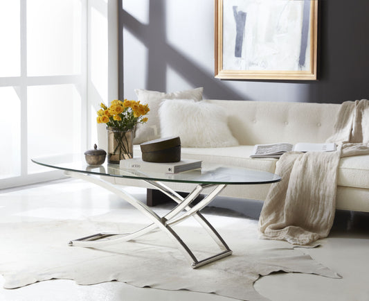 Pictured in this silo shot is the Playa Cocktail by Modern Elements Furniture in a stainless steel finish. This metal and glass cocktail table features a larger oval-shaped glass top that rests on a beautifully curved metal frame, creating a sleek and sophisticated silhouette. Finished in oil-rubbed bronze, satin brass, or stainless steel, the table's refined style and subtle curves make it a standout piece for living rooms, lounges, or entertainment areas.