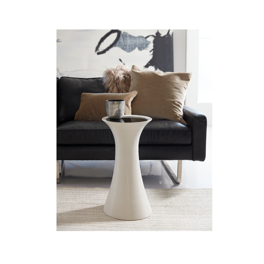 This is a lifestyle shot of the Cota by Modern Elements placed in a contemporary living room, shown here in a white finish with a black glass insert