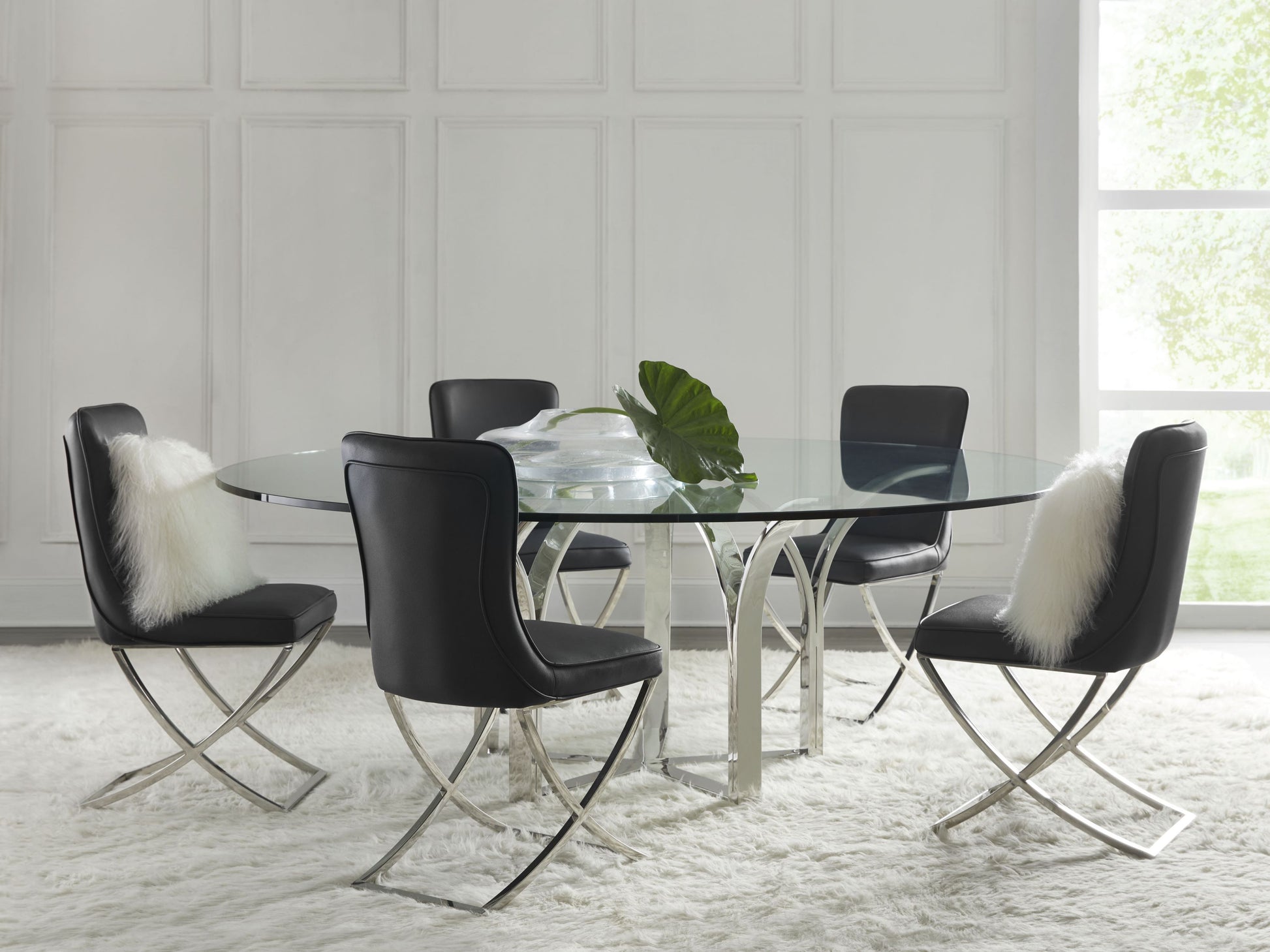 Pictured here in this lifestyle shot, The Trellis Dining Table brings a blend of elegance and modern design to any dining area. Available in 72" and 84" diameter options, this dining table features a sturdy stainless steel base that mirrors the intricate geometric patterns of a classic trellis design, creating a striking visual appeal.