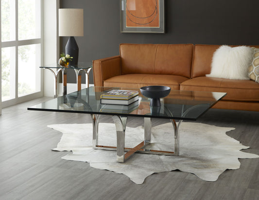 Pictured here in this lifestyle shot, The Trellis Square Cocktail Table by Modern Elements combines contemporary elegance with a classic geometric aesthetic, making it the perfect centerpiece for any living room or lounge area. This square cocktail table features a sturdy stainless steel base with intricate, clean lines inspired by a traditional trellis design, adding a touch of architectural interest to your decor. 
