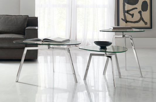 Pictured here in this lifestyle photo, The Trio Nesting Tables set is a modern and versatile addition to any living room or lounge area, offering both style and functionality.

This set of three distinctly sized accent tables features a sleek stainless steel base with three slender legs that create a minimalist yet sturdy foundation. Topped with chic glass table-tops, these nesting tables exude contemporary elegance and provide flexible solutions for any space.