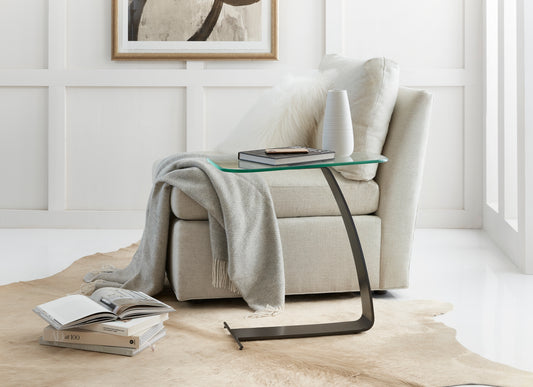 Pictured here in this lifestyle shot in an oil-rubbed bronze finish, The Valet Pull-Up Accent Table is the epitome of modern elegance, combining the sleek design of its unique sculptural elements with functional versatility.

Available in luxurious satin brass, polished or brushed stainless steel, and oil-rubbed bronze finishes, these pull-up accent tables feature a sleek, simplistic metal frame crafted from a single piece of metal, creating a clean and contemporary silhouette.

